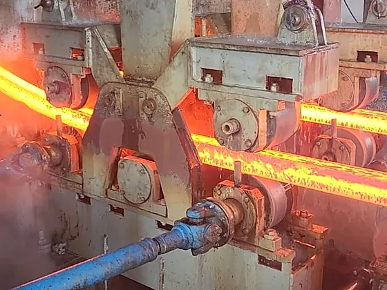 Hot steel bar passing through a rolling stand at the PSML mill