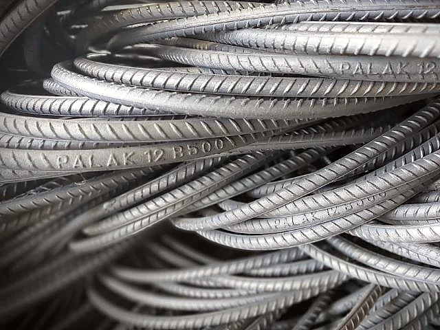 Coiled PALAK 12 B500 TMT rebars with the Palak brand rolled into the bar
